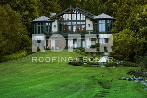 big house with combination roof and glass windows