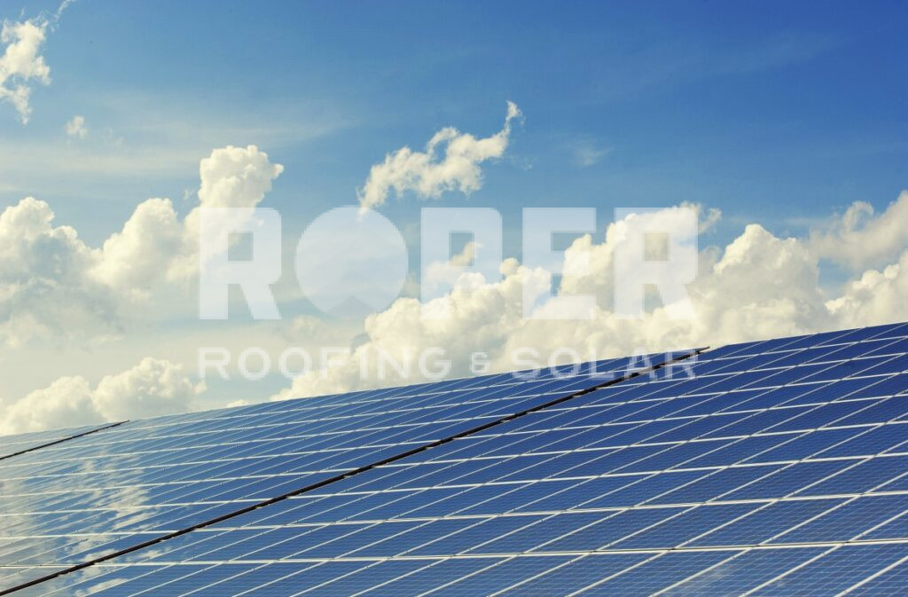 Blue solar panels against cloudy sky - renewable energy installation