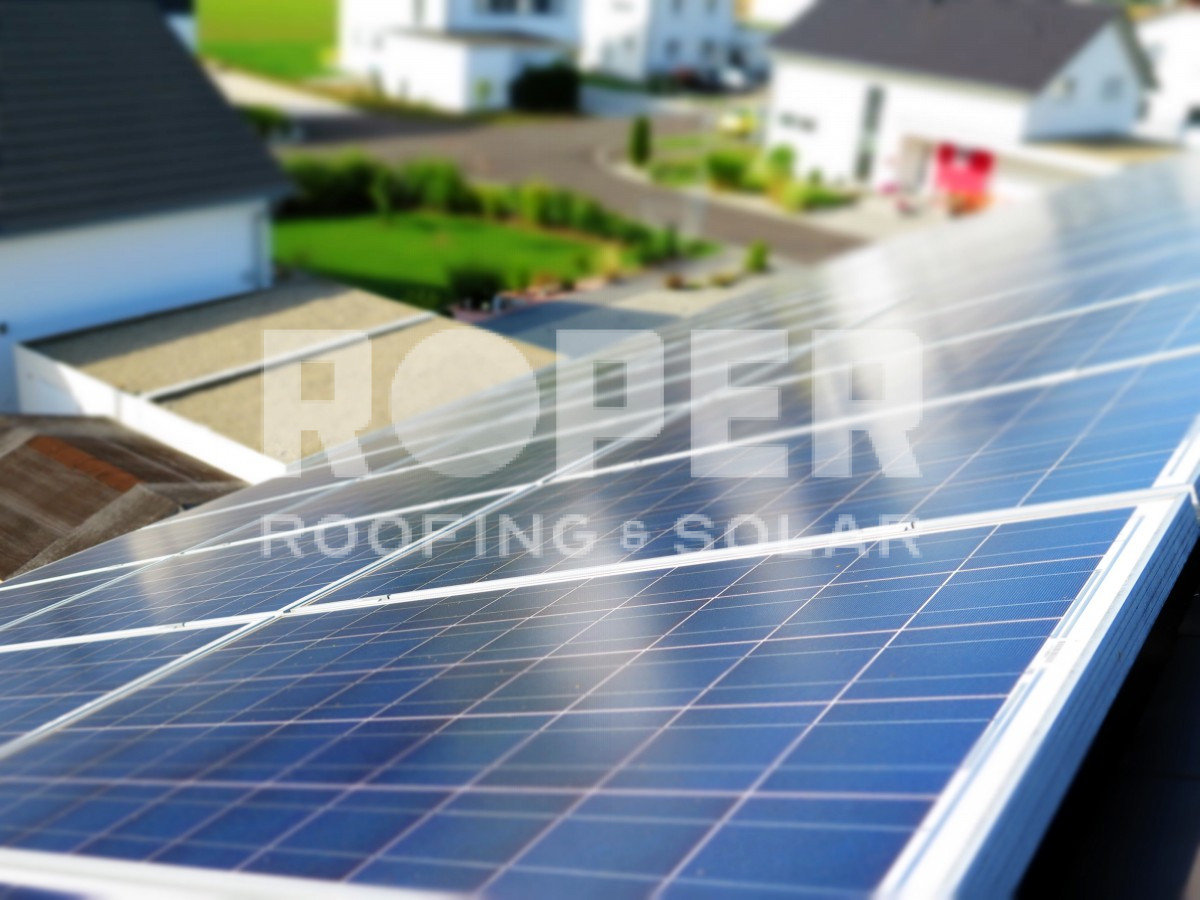 Blue solar panels installed on residential rooftop for renewable energy generation