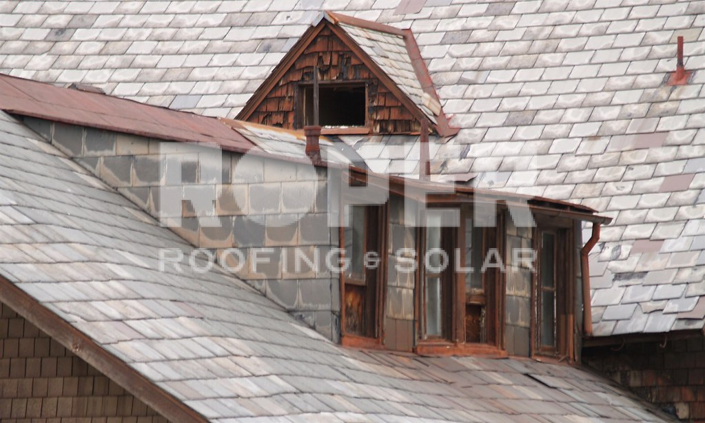 Slate roof with copper dormers and cedar shingle siding on residential home