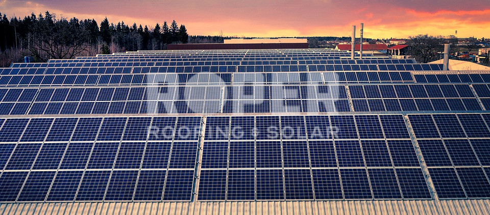 Solar panel farm with rows of photovoltaic panels at sunset with colorful sky