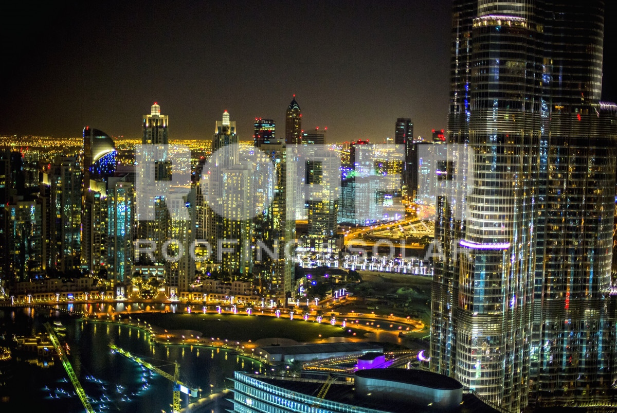 Illuminated city skyline at night with glowing skyscrapers and urban lights