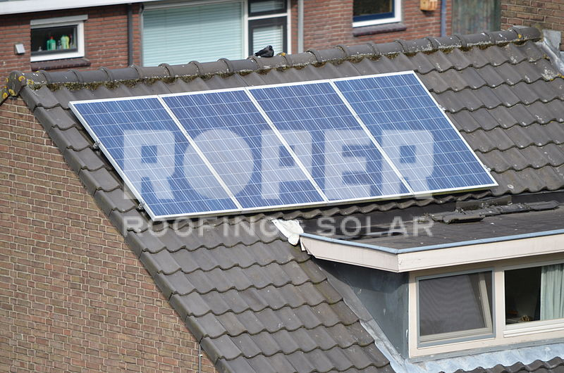 Solar panels installed on residential brick house roof for renewable energy