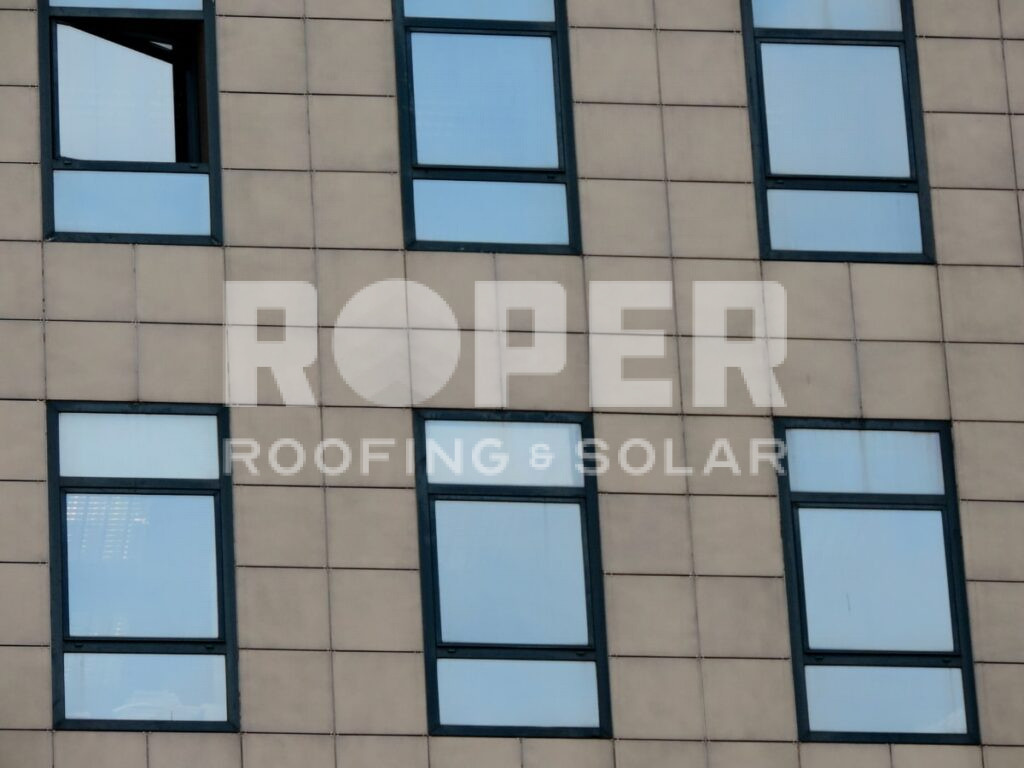 Roper Roofing & Solar company building facade with beige exterior and dark windows
