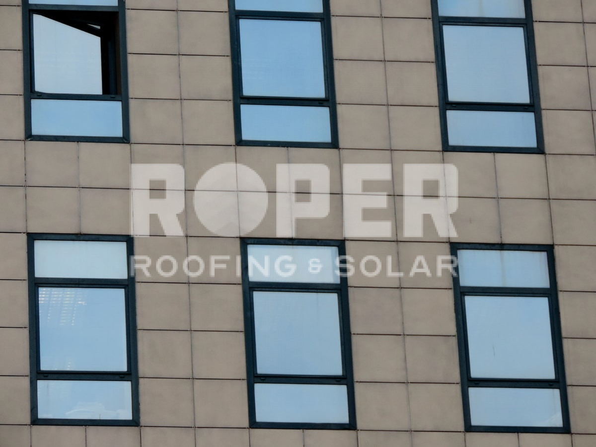 Roper Roofing & Solar company building facade with beige exterior and dark windows