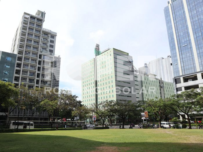 Modern city skyline with tall buildings and green park in foreground