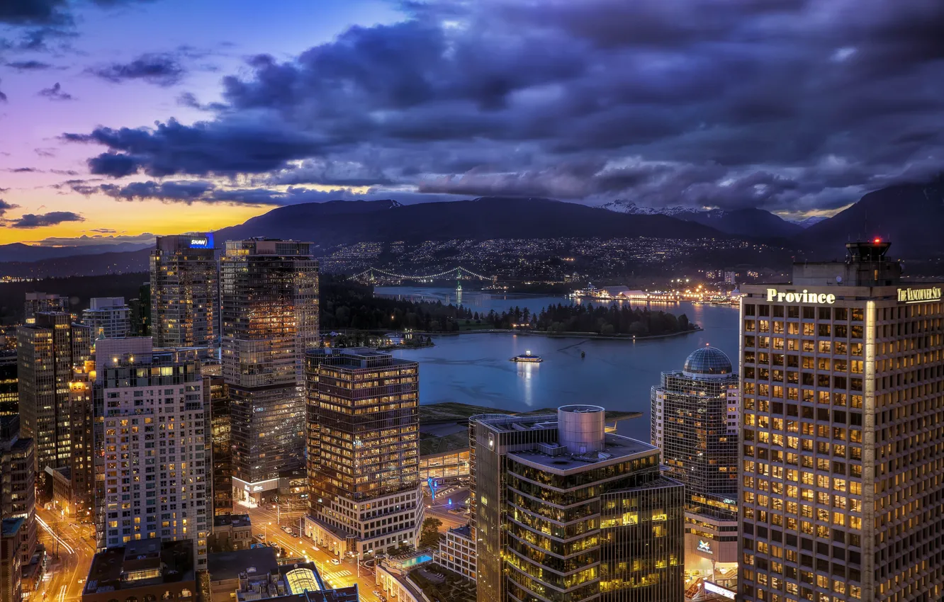 Vancouver downtown skyline at dusk with illuminated buildings and harbor view