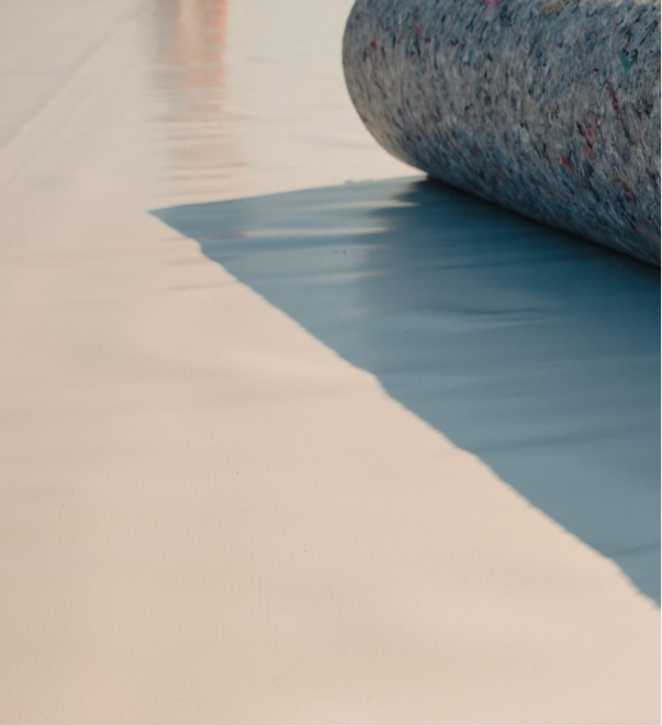 Ocean wave gently rolling onto sandy beach shore with smooth water and sand